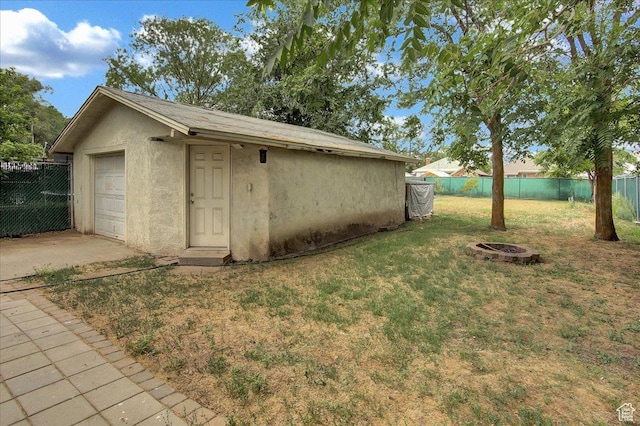 3241 Grant Ave, Ogden, UT 84401 - view of yard with driveway, an outdoor fire pit, a detached garage, and an outdoor structure