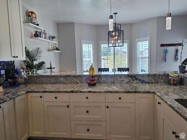 826 S 300 W, Vernal, UT 84078 - kitchen with open shelves, white cabinets, pendant lighting, dark stone countertops, and a chandelier