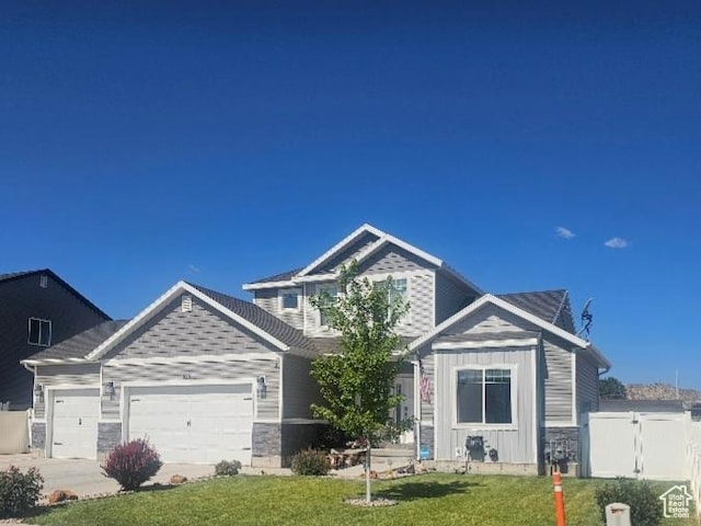 826 S 300 W, Vernal, UT 84078 - view of front of property with a garage, stone siding, a gate, driveway, and board and batten siding