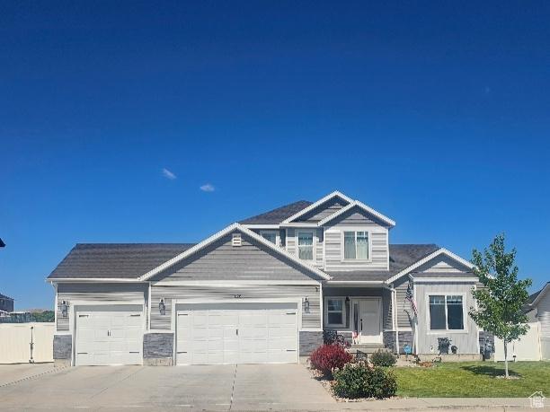 826 S 300 W, Vernal, UT 84078 - view of front of property with concrete driveway, an attached garage, and stone siding
