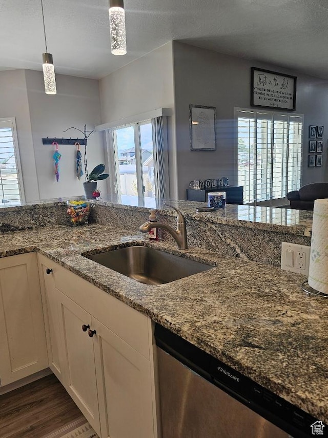 826 S 300 W, Vernal, UT 84078 - kitchen featuring stainless steel dishwasher, stone counters, wood finished floors, white cabinets, and pendant lighting