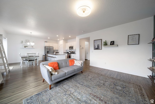14837 S Messi St, Herriman, UT 84096 - living room featuring a chandelier, dark wood finished floors, and recessed lighting