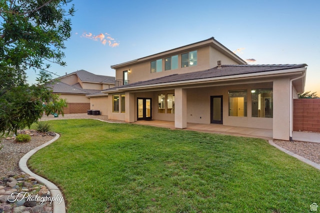 2762 E Hazel Dr, St George, UT 84790 - back of property at dusk featuring stucco siding, french doors, and a patio area
