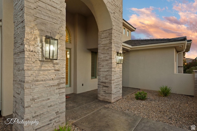 2762 E Hazel Dr, St George, UT 84790 - exterior entry at dusk with stucco siding and a patio area