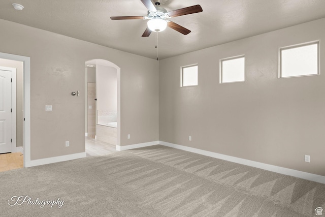 2762 E Hazel Dr, St George, UT 84790 - unfurnished room featuring arched walkways, light colored carpet, ceiling fan, and a smoke detector
