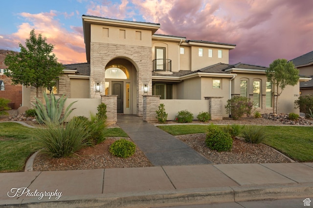 2762 E Hazel Dr, St George, UT 84790 - view of front of home featuring stone siding, stucco siding, and a fenced front yard