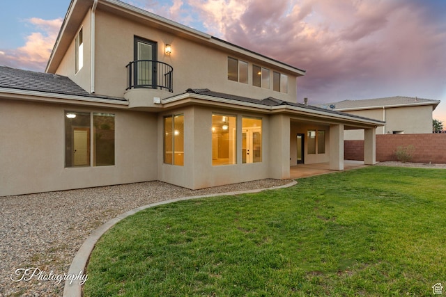 2762 E Hazel Dr, St George, UT 84790 - back of house at dusk with a balcony, a patio area, and stucco siding