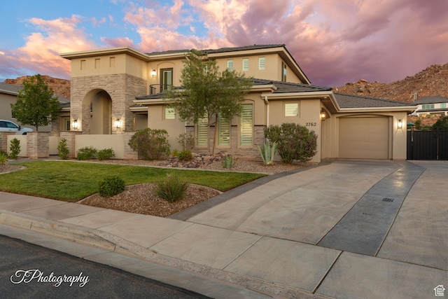 2762 E Hazel Dr, St George, UT 84790 - view of front of house with stucco siding, driveway, stone siding, and an attached garage
