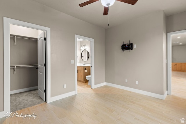 2762 E Hazel Dr, St George, UT 84790 - unfurnished bedroom featuring a walk in closet, light wood-style floors, ensuite bathroom, and a closet