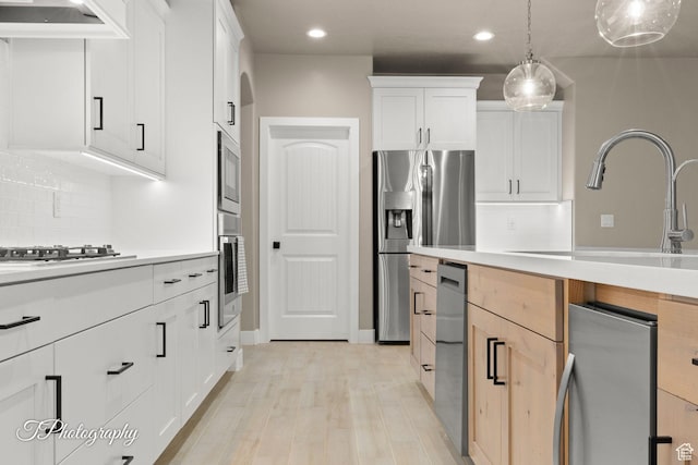 2762 E Hazel Dr, St George, UT 84790 - kitchen featuring recessed lighting, light countertops, stainless steel appliances, backsplash, and custom exhaust hood
