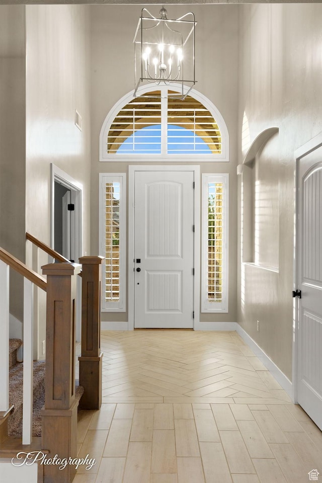 2762 E Hazel Dr, St George, UT 84790 - foyer entrance with a high ceiling, a chandelier, stairs, and healthy amount of natural light
