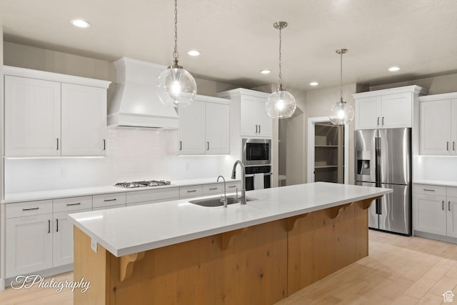 2762 E Hazel Dr, St George, UT 84790 - kitchen with appliances with stainless steel finishes, custom range hood, a kitchen breakfast bar, light countertops, and recessed lighting
