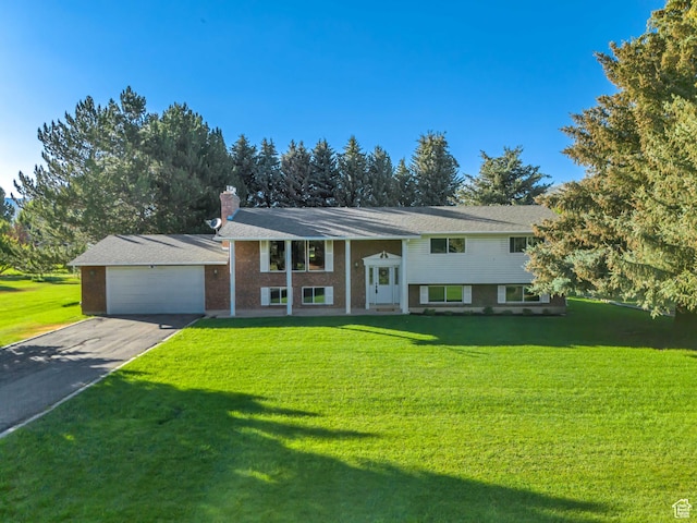 4918 E 2800 N, Eden, UT 84310 - raised ranch with driveway, a front lawn, a chimney, and brick siding