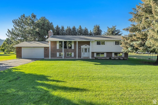 4918 E 2800 N, Eden, UT 84310 - raised ranch featuring a garage, a front yard, asphalt driveway, and a chimney