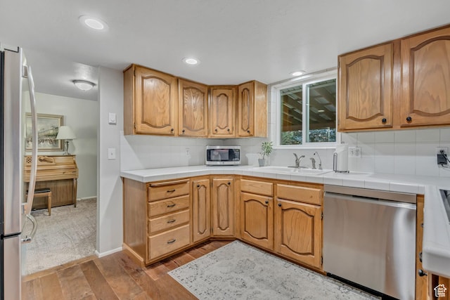 4918 E 2800 N, Eden, UT 84310 - kitchen with appliances with stainless steel finishes, wood finished floors, decorative backsplash, recessed lighting, and light countertops