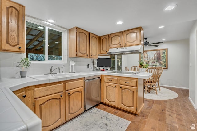 4918 E 2800 N, Eden, UT 84310 - kitchen with dishwasher, under cabinet range hood, a peninsula, light wood-type flooring, and decorative backsplash
