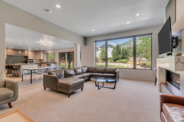 22 S Sunwood Ln, Sandy, UT 84092 - living room featuring recessed lighting, light colored carpet, and a glass covered fireplace