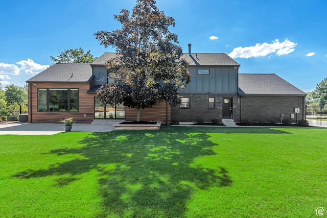 22 S Sunwood Ln, Sandy, UT 84092 - rear view of property featuring board and batten siding, a patio, and roof with shingles