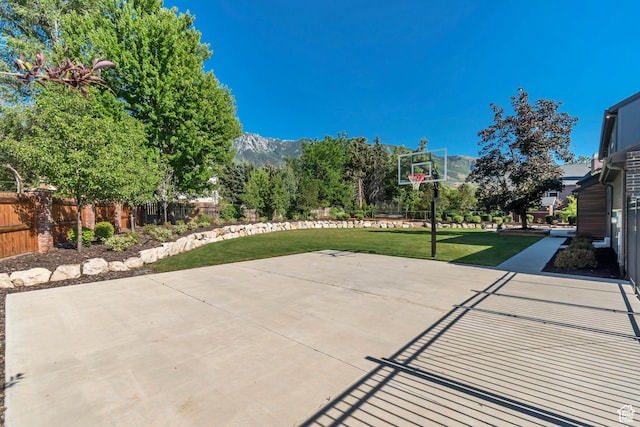22 S Sunwood Ln, Sandy, UT 84092 - view of patio with basketball hoop and a mountain view