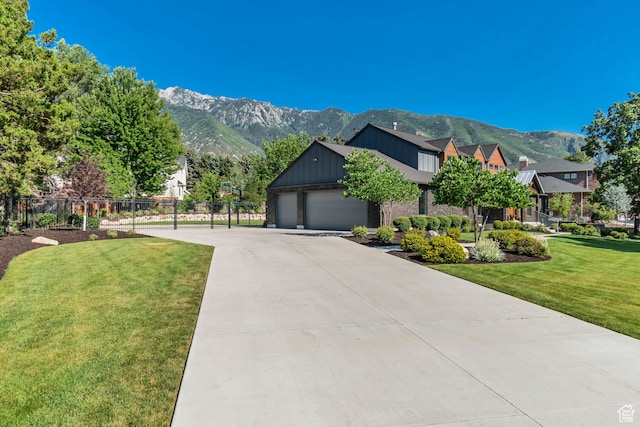 22 S Sunwood Ln, Sandy, UT 84092 - view of front of property with a mountain view, an attached garage, board and batten siding, and driveway