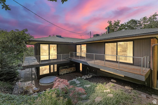 4352 S Zarahemla Dr, Salt Lake City, UT 84124 - back of house at dusk featuring a wooden deck and roof with shingles