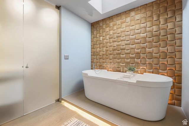 4352 S Zarahemla Dr, Salt Lake City, UT 84124 - bathroom featuring a skylight, a soaking tub, and wood finished floors