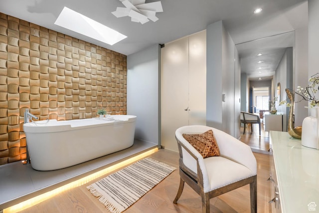 4352 S Zarahemla Dr, Salt Lake City, UT 84124 - bathroom featuring a skylight, a freestanding bath, wood finished floors, and recessed lighting