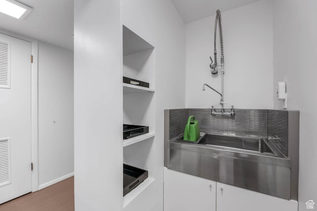 4352 S Zarahemla Dr, Salt Lake City, UT 84124 - kitchen featuring stainless steel counters, white cabinets, wood finished floors, open shelves, and tasteful backsplash