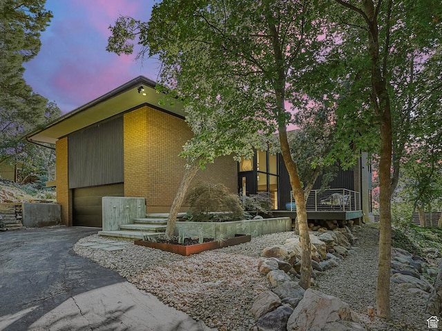 4352 S Zarahemla Dr, Salt Lake City, UT 84124 - view of front of property with a garage, driveway, and brick siding