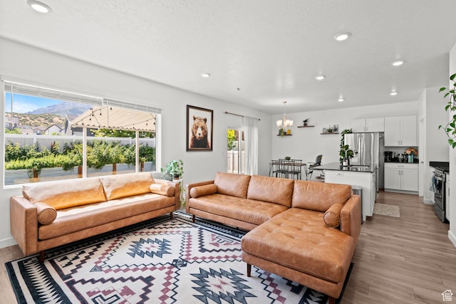 1017 S Red Cliff Dr, Santaquin, UT 84655 - living room featuring light wood finished floors, recessed lighting, and a chandelier