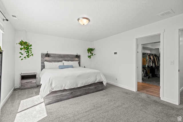 1017 S Red Cliff Dr, Santaquin, UT 84655 - carpeted bedroom featuring a spacious closet and a textured ceiling