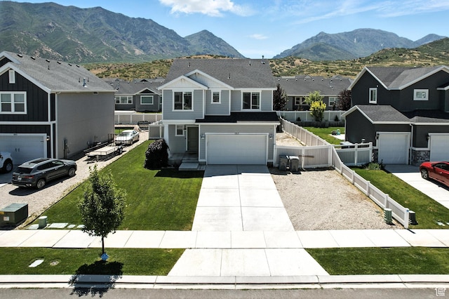 1017 S Red Cliff Dr, Santaquin, UT 84655 - view of front facade featuring a residential view, concrete driveway, a mountain view, and an attached garage