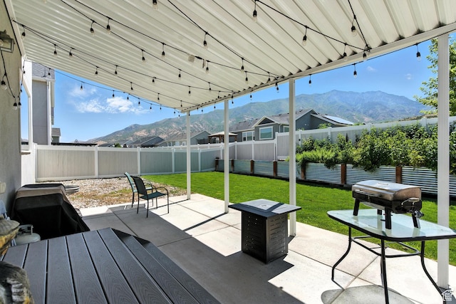 1017 S Red Cliff Dr, Santaquin, UT 84655 - fenced backyard featuring a mountain view and a patio