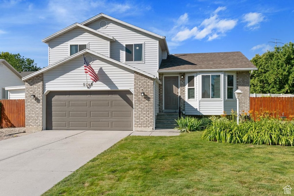 5745 W Hunter Hollow Dr S, Salt Lake City, UT 84128 - split level home with brick siding, an attached garage, driveway, a shingled roof, and entry steps