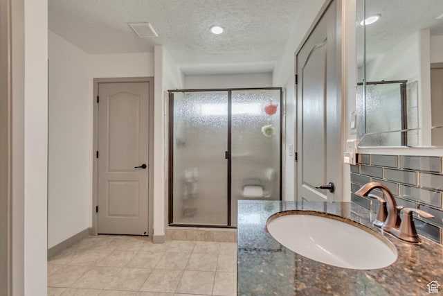 11874 S Rushmore Park Ln W, Herriman, UT 84096 - bathroom with a textured ceiling, a shower stall, vanity, and tile patterned floors