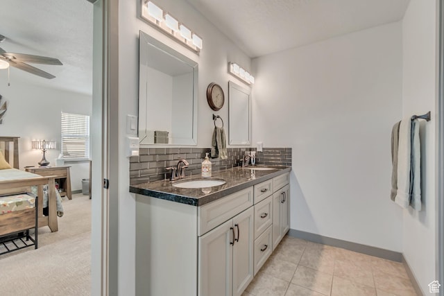 11874 S Rushmore Park Ln W, Herriman, UT 84096 - full bathroom with double vanity, ceiling fan, backsplash, and tile patterned flooring