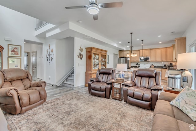 11874 S Rushmore Park Ln W, Herriman, UT 84096 - living area with a chandelier, stairs, a ceiling fan, recessed lighting, and light wood-type flooring