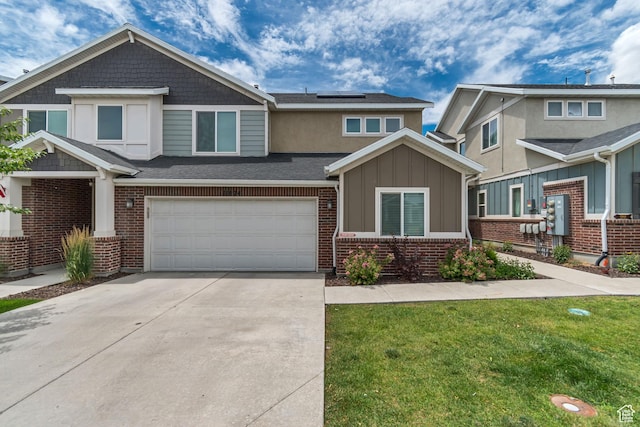 11874 S Rushmore Park Ln W, Herriman, UT 84096 - view of front of home featuring solar panels, concrete driveway, an attached garage, a front yard, and board and batten siding