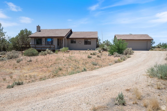 1387 N Mount Zion Dr, Apple Valley, UT 84737 - single story home with a chimney, dirt driveway, a garage, an outdoor structure, and stucco siding