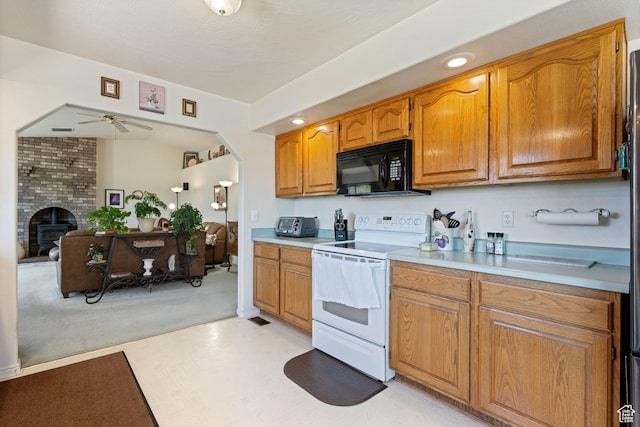 1387 N Mount Zion Dr, Apple Valley, UT 84737 - kitchen featuring black microwave, white electric range, a ceiling fan, light countertops, and brown cabinets