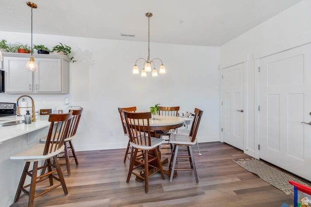 1831 W Newcastle Ln Unit 101, Saratoga Springs, UT 84045 - dining room featuring wood finished floors and a chandelier