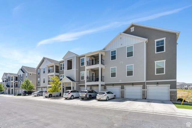 1831 W Newcastle Ln Unit 101, Saratoga Springs, UT 84045 - view of building exterior with an attached garage, driveway, and a residential view