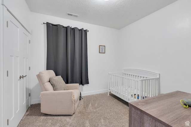 1831 W Newcastle Ln Unit 101, Saratoga Springs, UT 84045 - bedroom with carpet flooring, a textured ceiling, and a nursery area