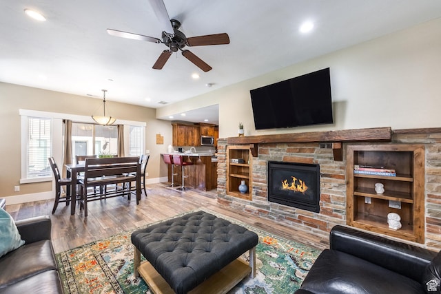 13602 N Hillclimb Ln, Kamas, UT 84036 - living room featuring a ceiling fan, wood finished floors, recessed lighting, and a fireplace