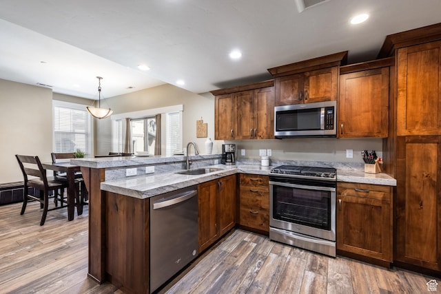 13602 N Hillclimb Ln, Kamas, UT 84036 - kitchen with stainless steel appliances, a peninsula, light wood finished floors, recessed lighting, and pendant lighting