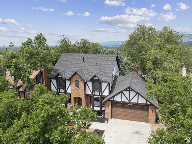 2255 E Camino Way Way S, Cottonwood Heights, UT 84121 - tudor-style house with an attached garage, brick siding, driveway, and a mountain view