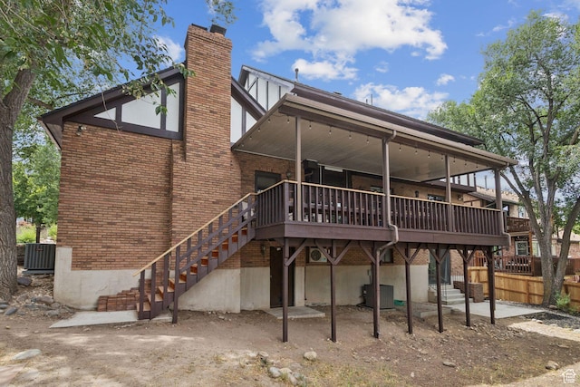 2255 E Camino Way Way S, Cottonwood Heights, UT 84121 - back of property with stairway, a chimney, a wooden deck, and brick siding