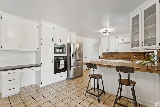 2255 E Camino Way Way S, Cottonwood Heights, UT 84121 - kitchen featuring oven, stainless steel refrigerator with ice dispenser, built in microwave, a breakfast bar area, and white cabinets