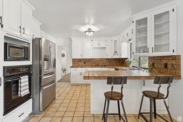 2255 E Camino Way Way S, Cottonwood Heights, UT 84121 - kitchen with black appliances, a peninsula, a breakfast bar, decorative backsplash, and white cabinetry