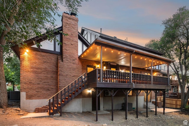2255 E Camino Way Way S, Cottonwood Heights, UT 84121 - rear view of house with a chimney, stairway, brick siding, and a wooden deck
